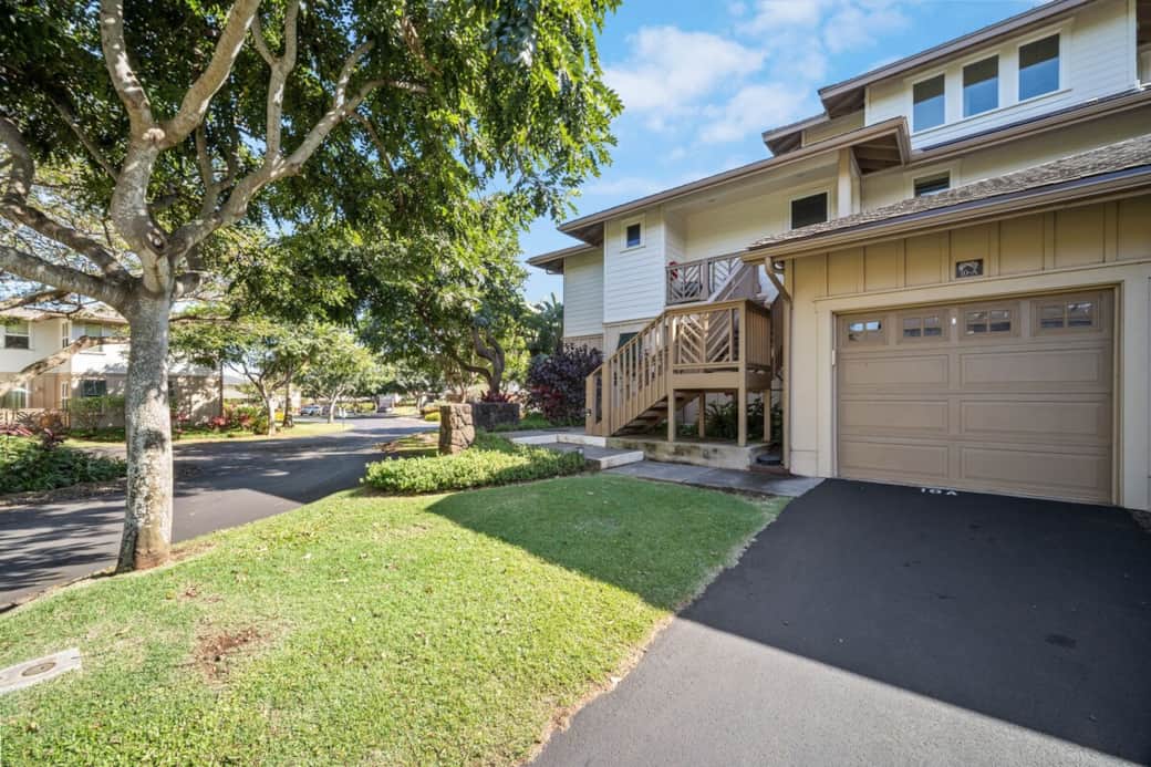 Unit 10A exterior with private garage and tree-lined streets in the Pili Mai community