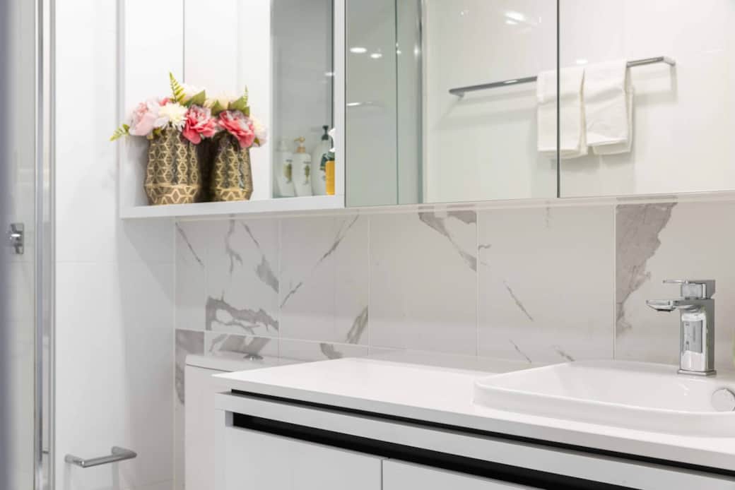 Indulge in the elegance of our bathroom, where every detail is meticulously designed. The marble backsplash and modern sink create a luxurious feel. The glass shower adds sophistication. This bathroom is ideal for guests to seek a spa-like experience