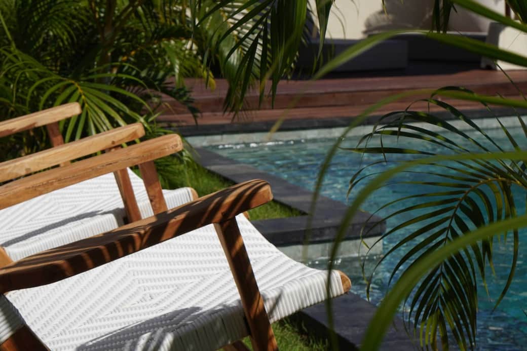 Unwind in the sun with a book or fresh coconut on our poolside loungers nestled in tropical greenery.