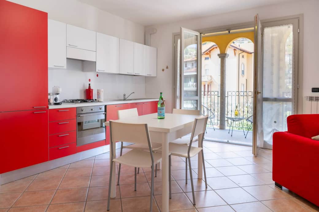 Ampio ed accogliente soggiorno con divano letto, smart TV, cucina open space e accesso diretto al balcone