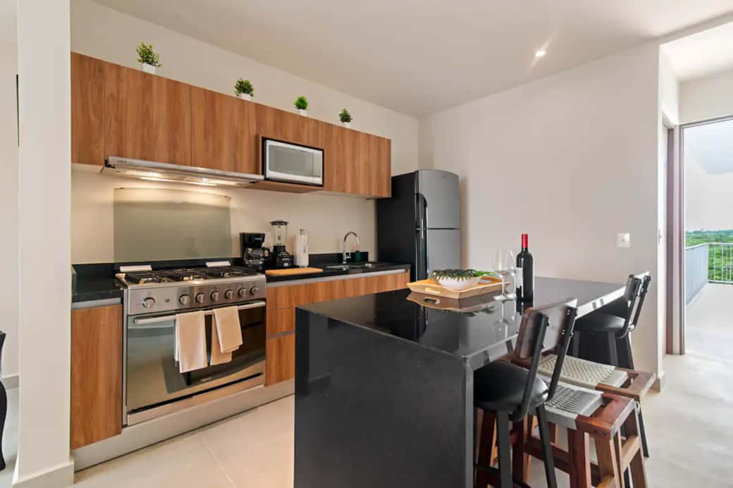 Ultimate culinary retreat: Fully stocked kitchen with coffee maker, blender. Enchanting jungle views