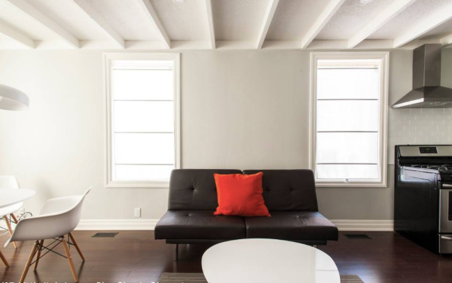 Sunlit and airy lounge space in a Toronto short-term lodging, both roomy and welcoming.