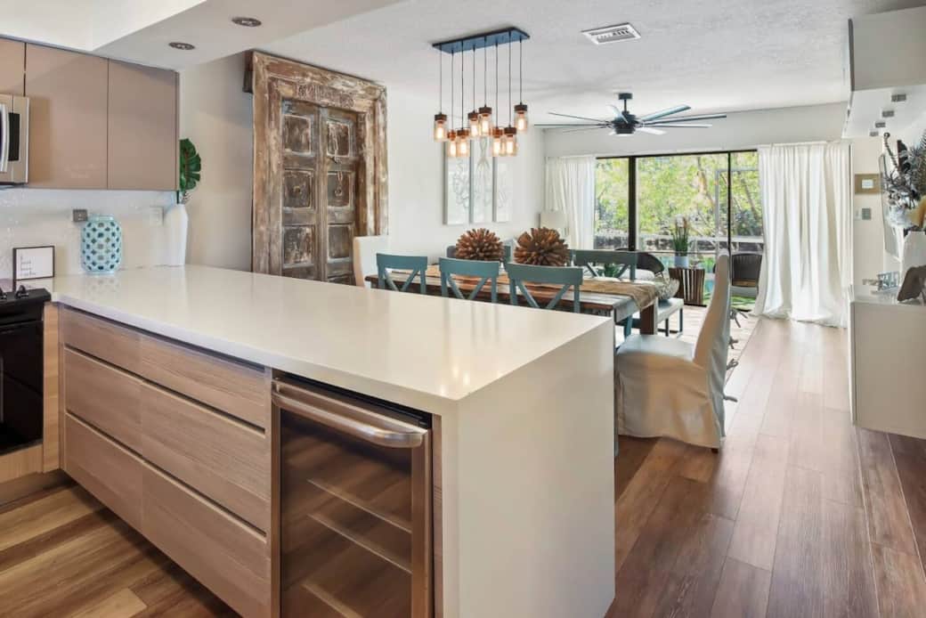 Fully remodeled kitchen with sleek countertops, stainless steel appliances, and a clean coastal design

