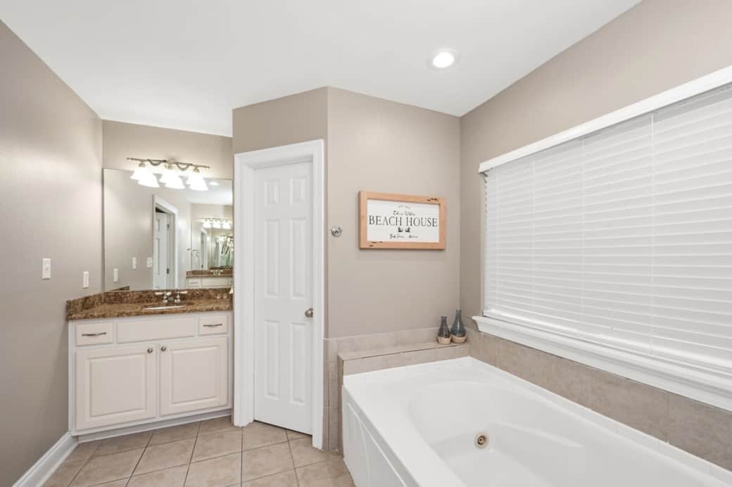 Master Bedroom Bathroom with His/Her sinks, jacuzzi tub, walk in shower, and private toilet room.  