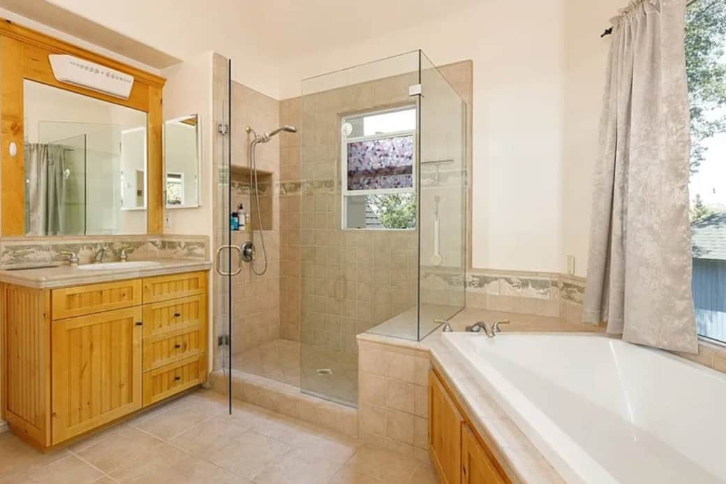 Walk in shower in main bedroom en suite with lake views out the window