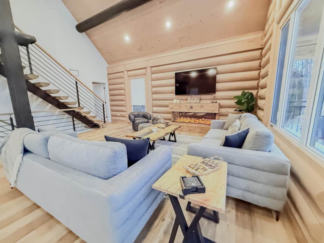 Salon avec foyer électrique offrant confort et ambiance chaleureuse