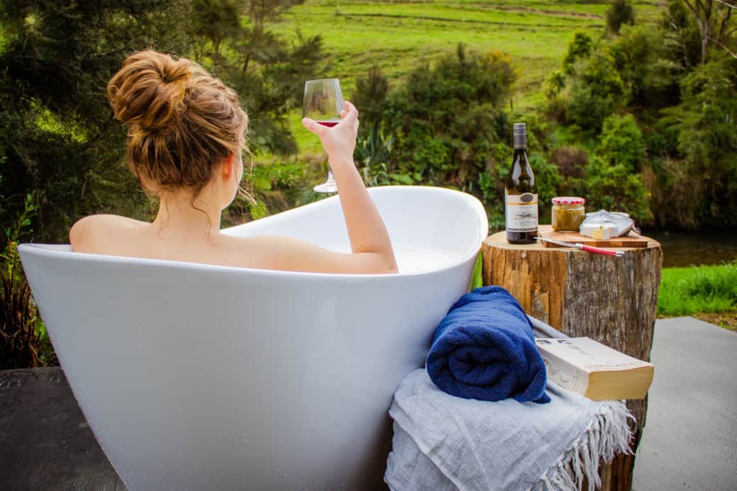 Romantic outdoor bath overlooking the river at River Song Cabin Ripples Retreat Piopio NZ