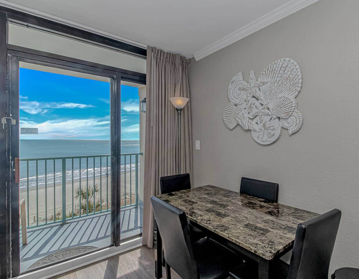 Cozy dining for four with unbeatable beachfront views.
