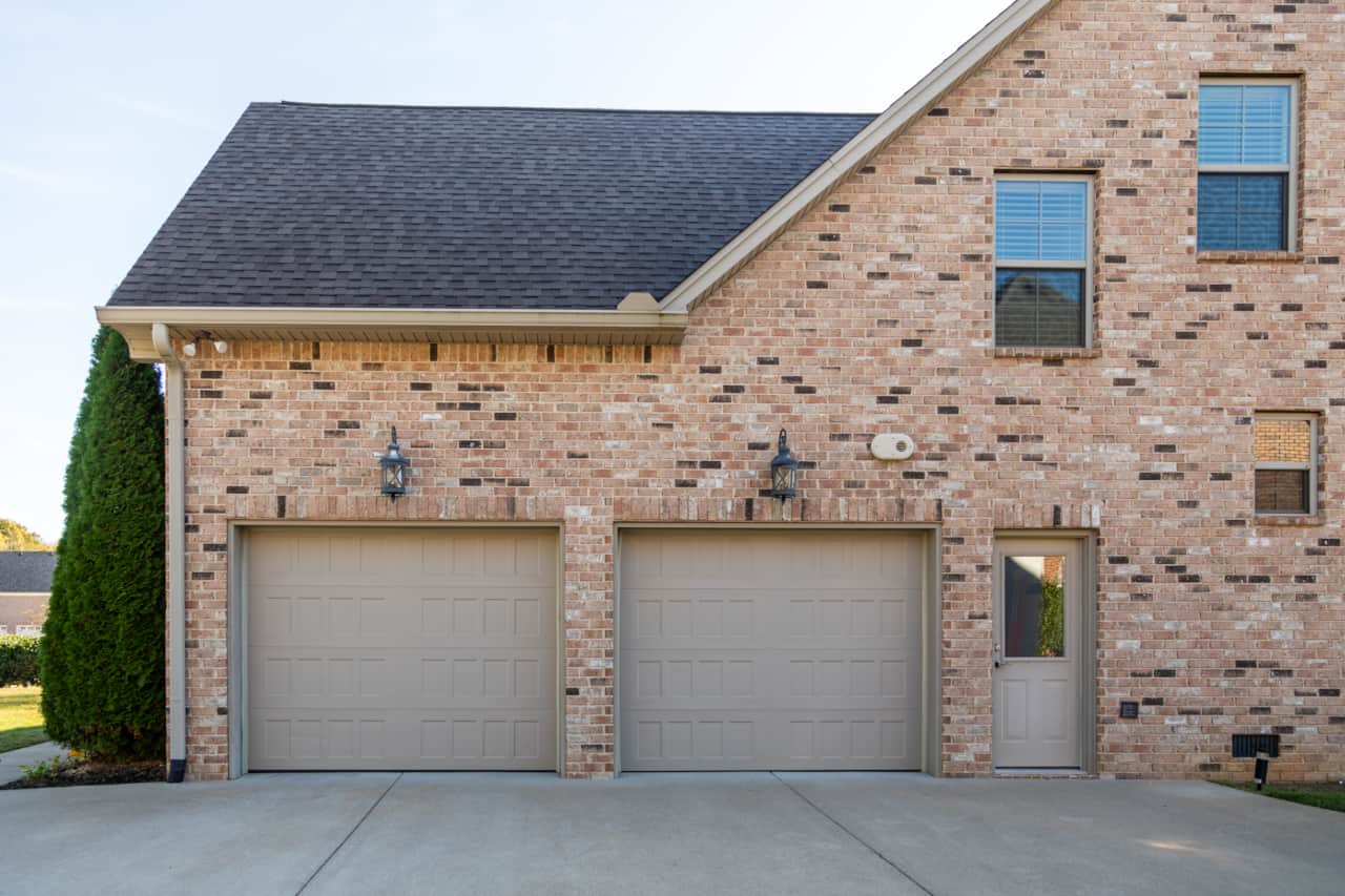 Two car garage and wide and long driveway. 