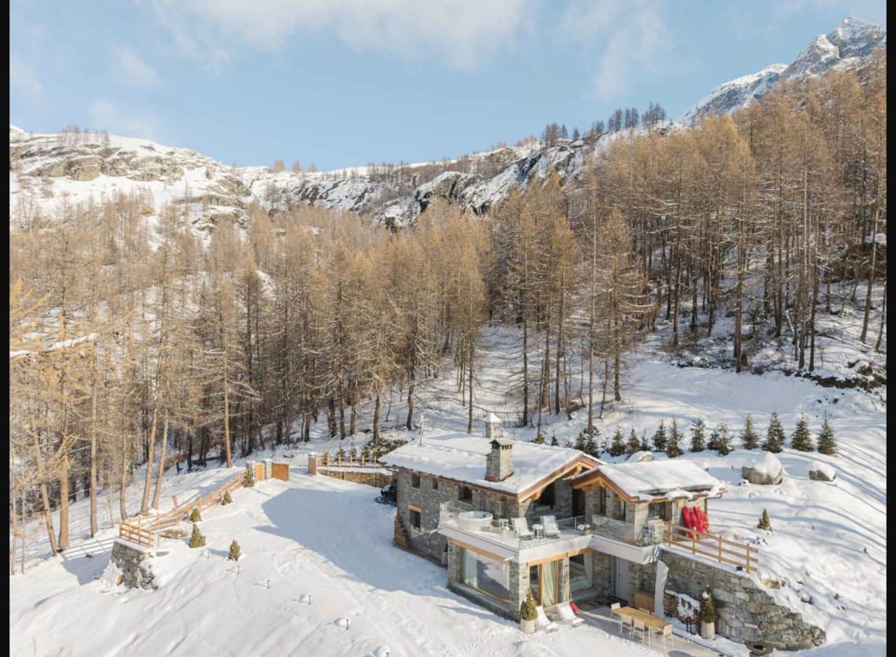 Aerial view of the chalet, alone in the larch forest