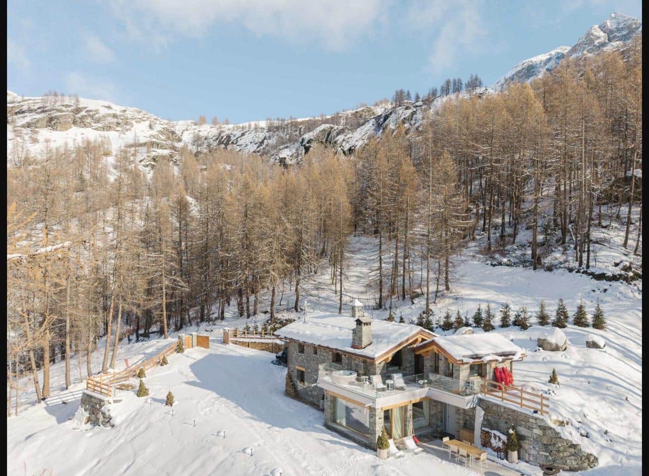 Aerial view of the chalet, alone in the larch forest