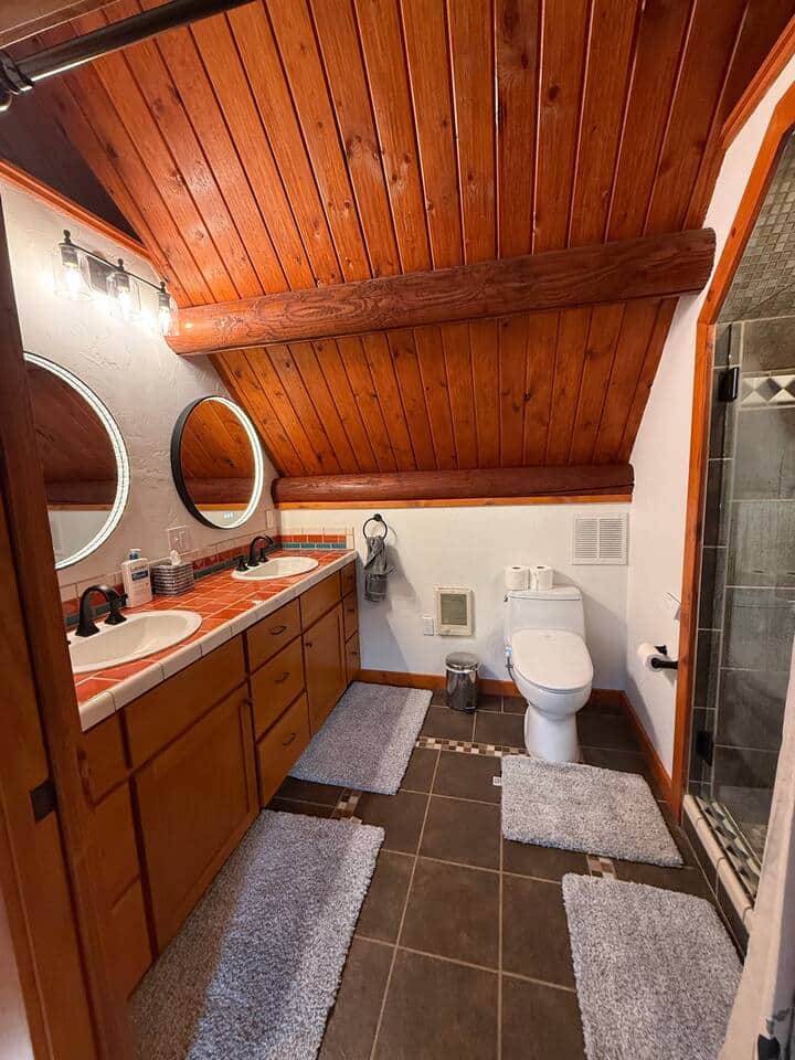 Upstairs bathroom featuring led mirrors and    moen bidet equipped toilet 
