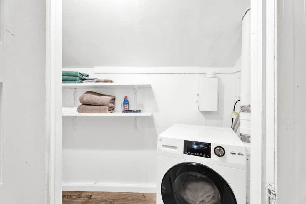 Washer/Dryer combo (all in one machine). Stain remover and detergent are provided. Clothing steamer is kept on laundry room shelf. 