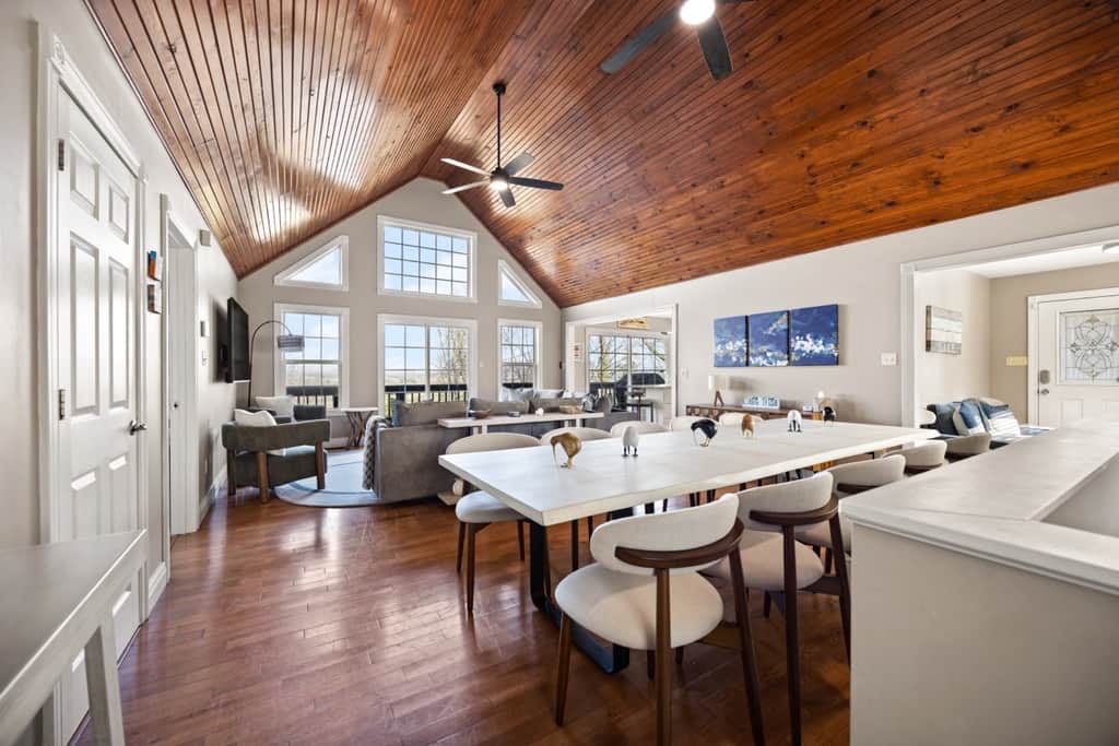 Step inside for a welcoming view through the dining area and living room to the patio doors beyond