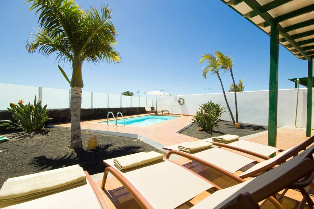 Sunny terrace with sun loungers beside the pool at Villa Costa Papagayo 24