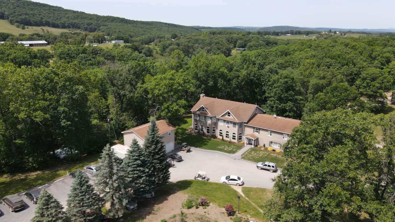 Aerial view of Haven of Hope Retreat surrounded by woods