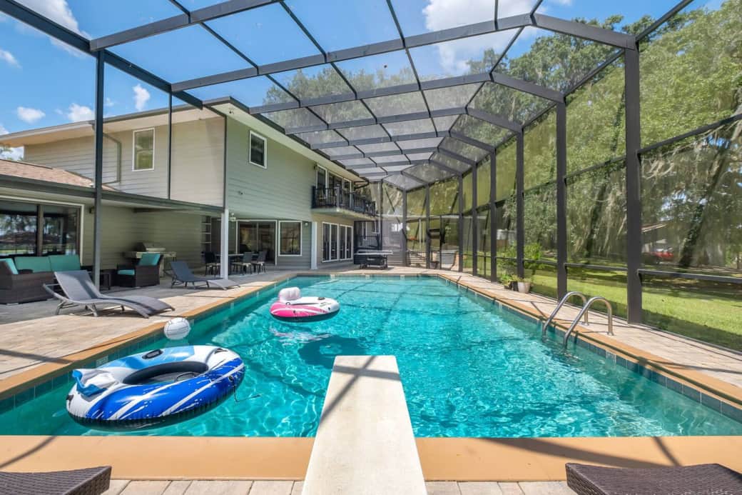 Enjoy the many amenities here in the screen enclosure. Ping pong, dining, sunning, lounging,  grill, pool, hot tub and half bath all in one space for your group's enjoyment.