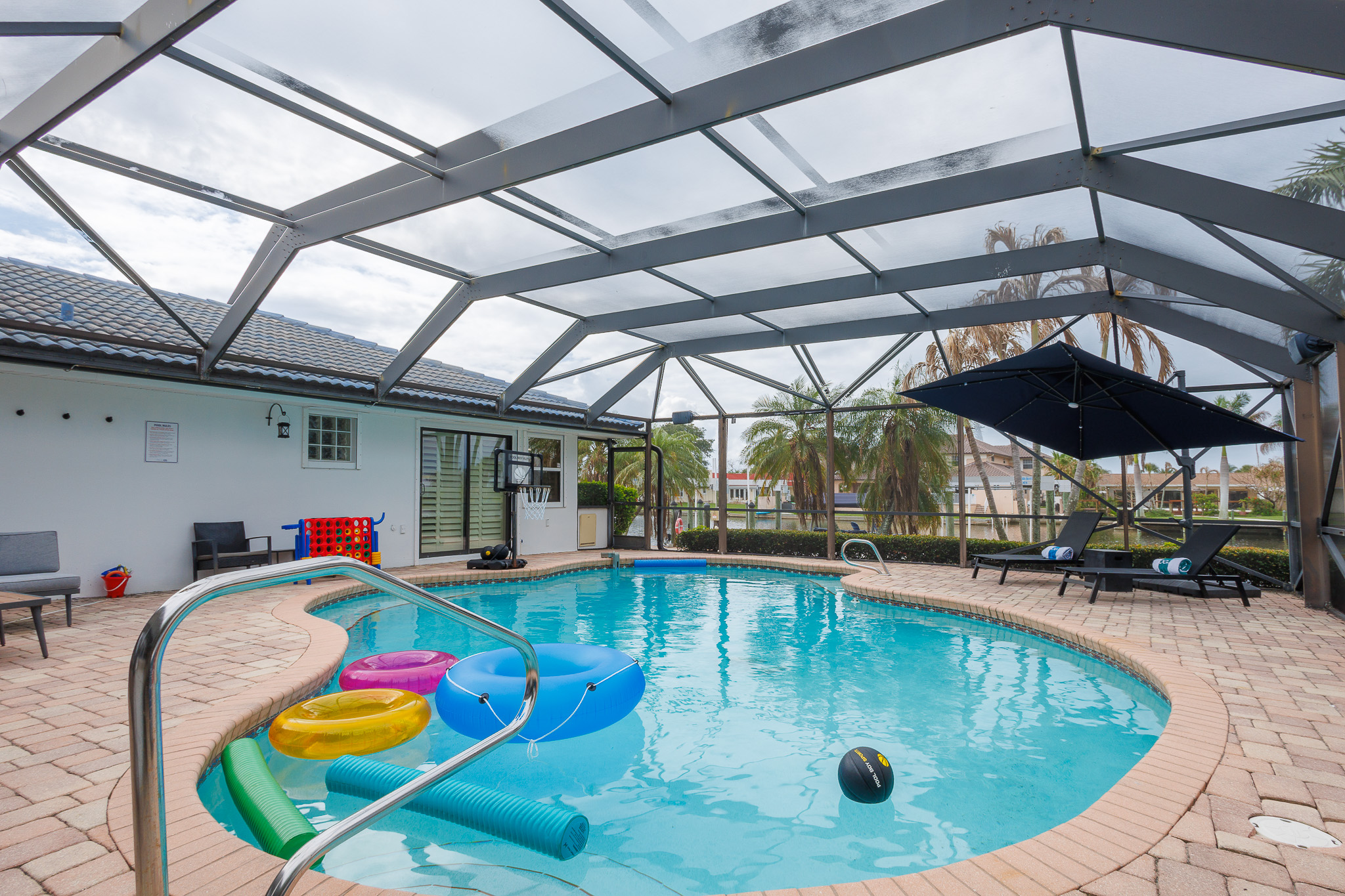 Make a splash in the private screened pool, complete with floats, games, and shaded loungers.