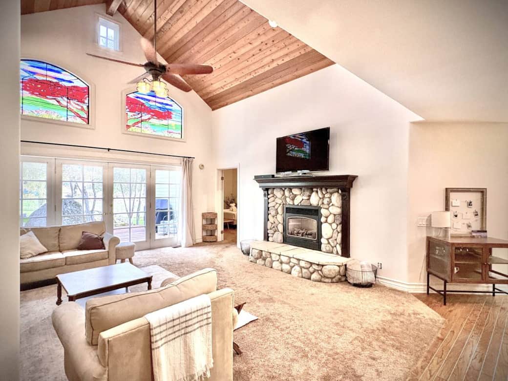 Unwind in our spacious living room featuring soaring ceilings, beautiful stained-glass windows, comfortable seating, and a large TV for gathering with family and friends. (Fireplace available during winter season only due to safety restrictions.) Unwind in our spacious living room featuring soaring ceilings, beautiful stained-glass windows, comfortable seating, and a large TV for gathering with family and friends. (Fireplace available during winter season only due to safety restrictions.)