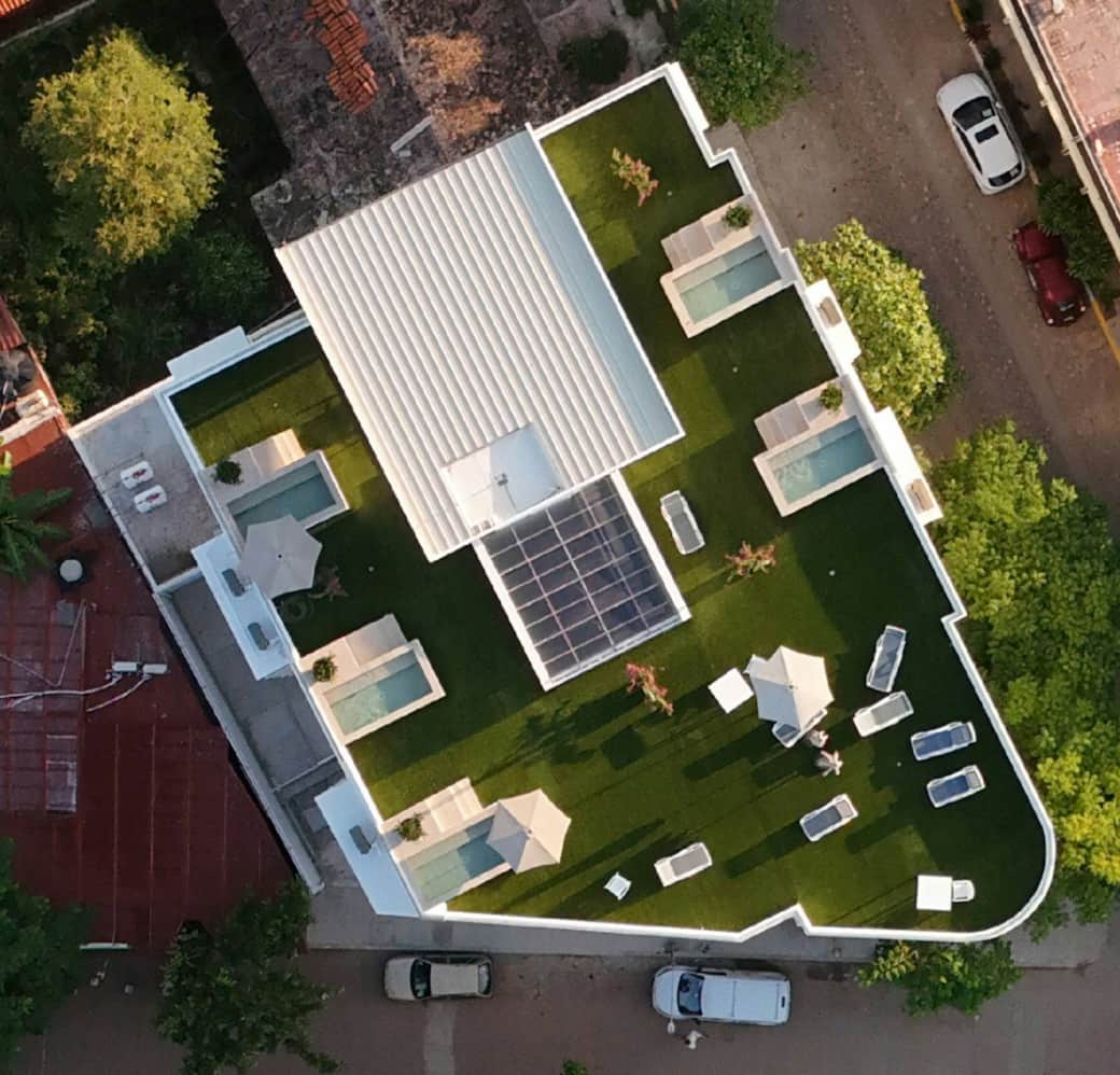 Drone view of La Esquina’s rooftop paradise with private pools and lounge spaces. Drone view of La Esquina’s rooftop paradise with private pools and lounge spaces.