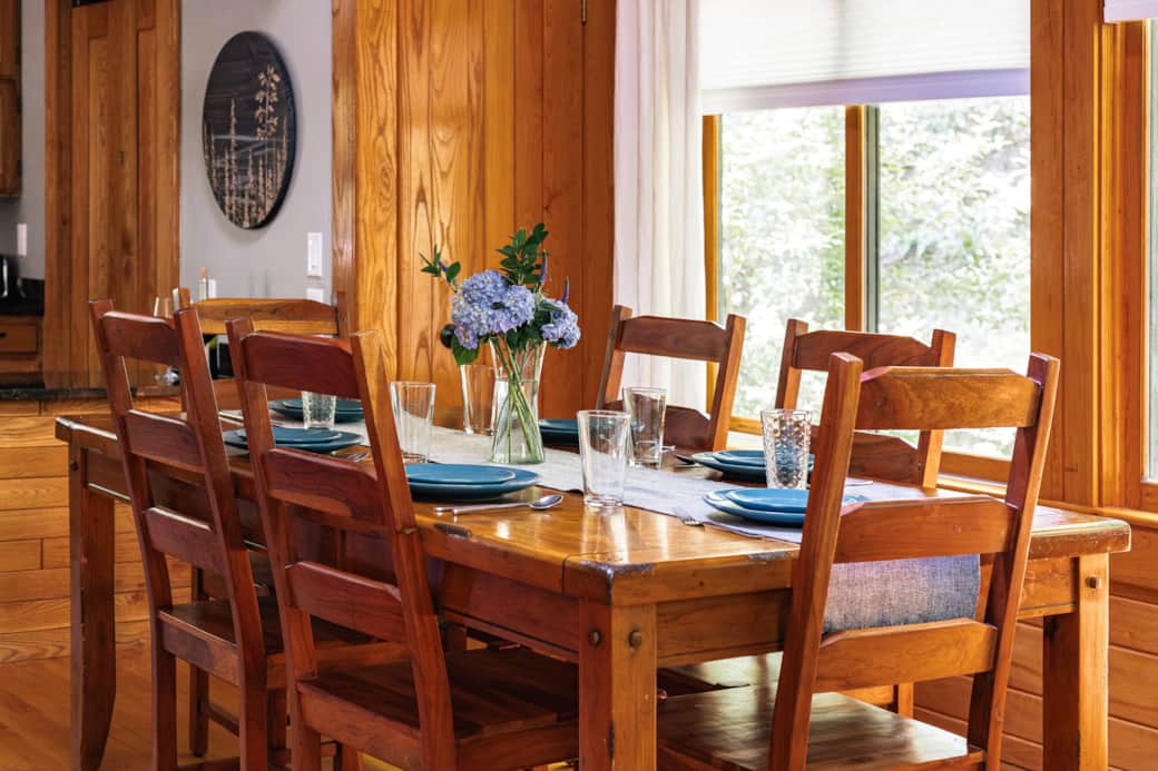 Dining table seats six.Perfect for meals, games, or planning fun with forest views and natural light