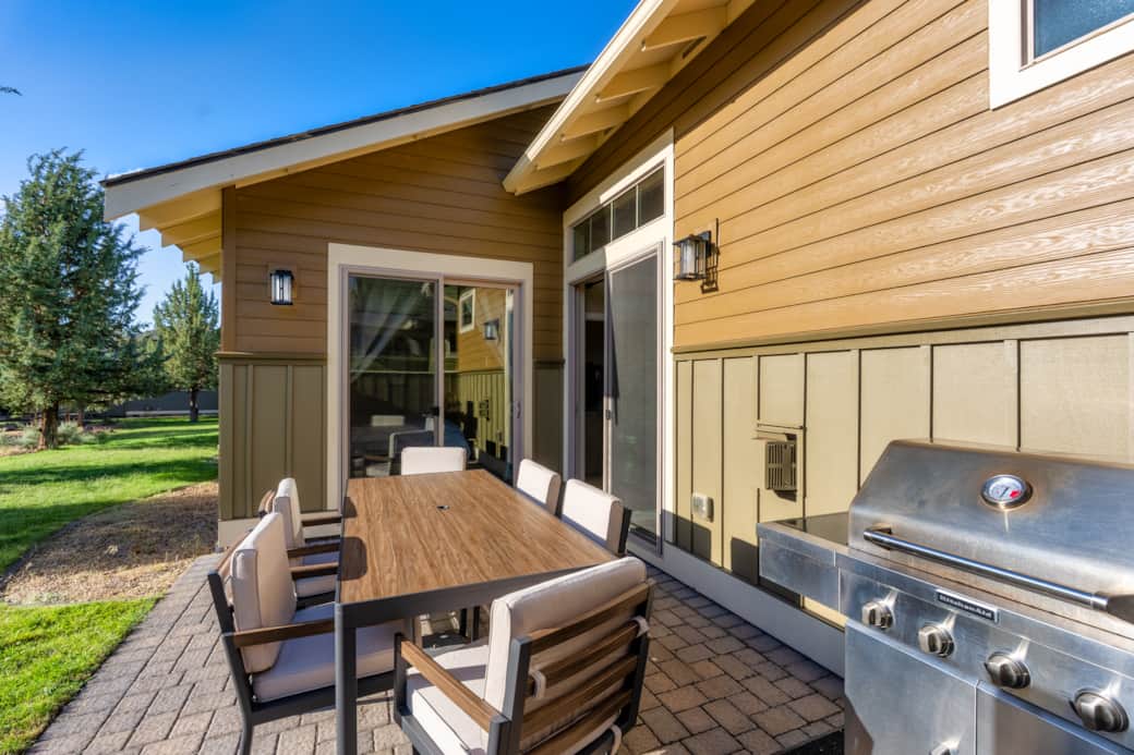 Private paver patio with KitchenAid gas grill and new outdoor dining set for six.