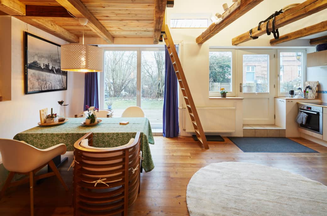 Open living room with dining table and access to the garden