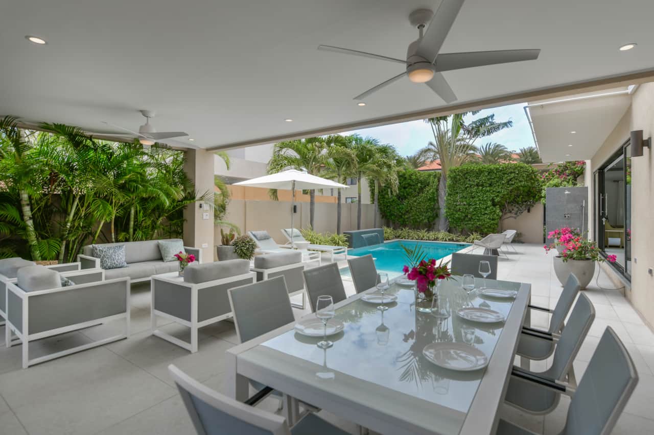 Backyard with covered gazebo area including dining, lounging and outdoor kitchen
