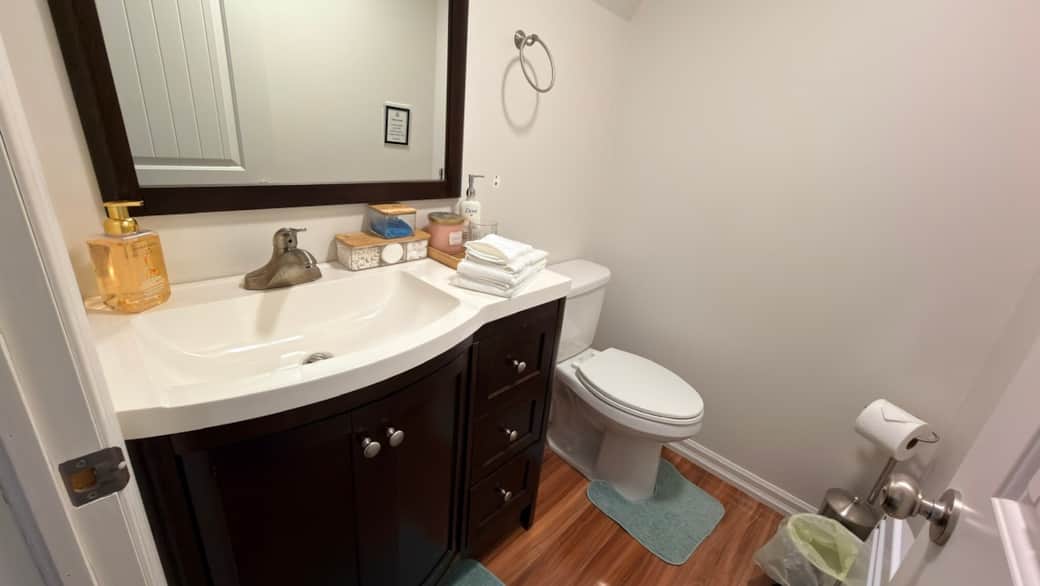 Ensuite bathroom with a stylish vanity, guest essentials, and a tidy, welcoming setup.