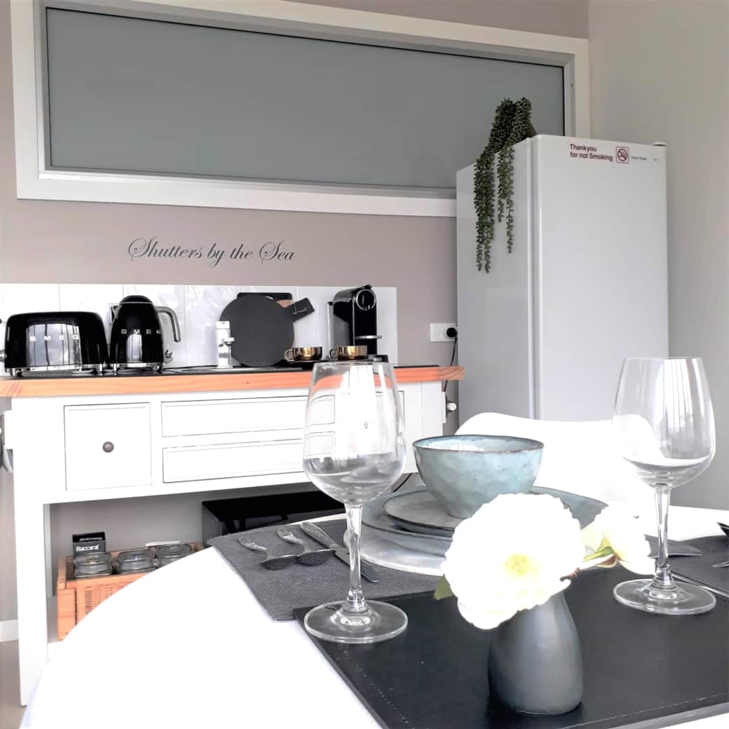 Modern kitchenette with luxury Smeg appliances for effortless, comfortable coastal living.