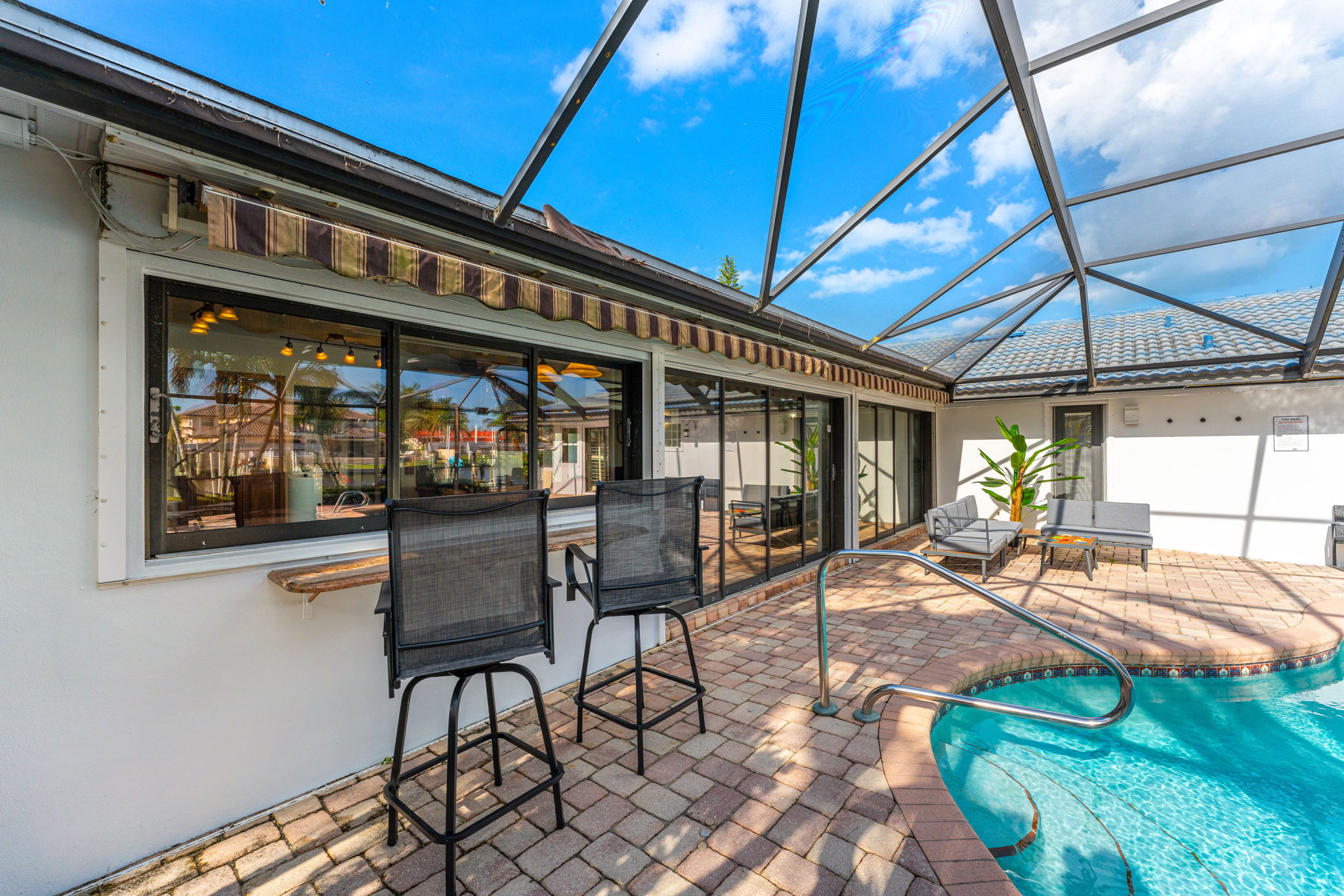 Take in the outdoor living space with plenty of seating for dining or lounging by the pool.