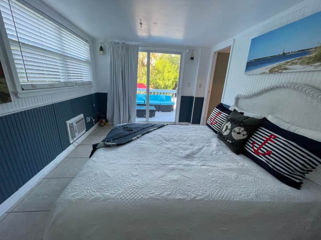 First floor queen bedroom. Glass sliding door to outside seating area.