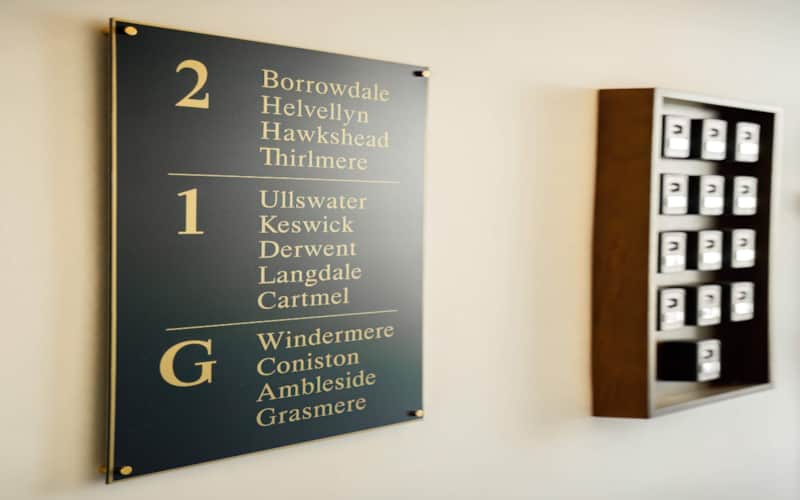 Apartment name board and key boxes in the entrance hall