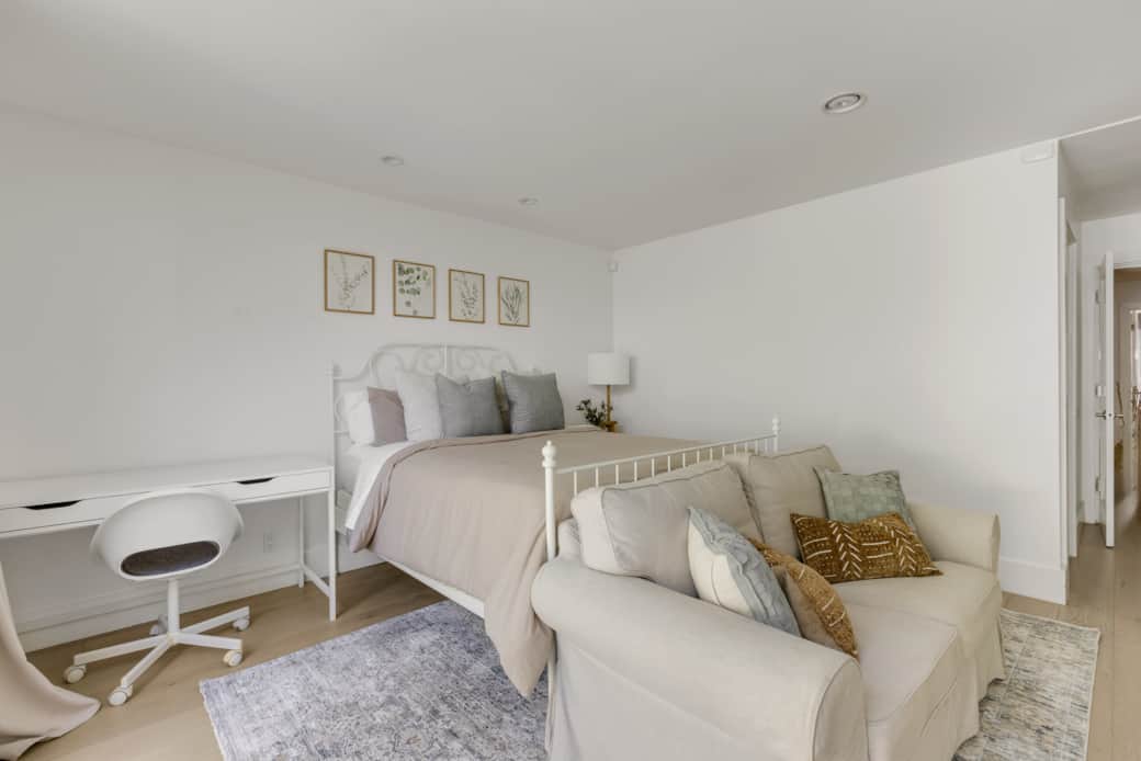 This bedroom also includes its own workspace complete with a desk and chair. This bedroom also includes its own workspace complete with a desk and chair.