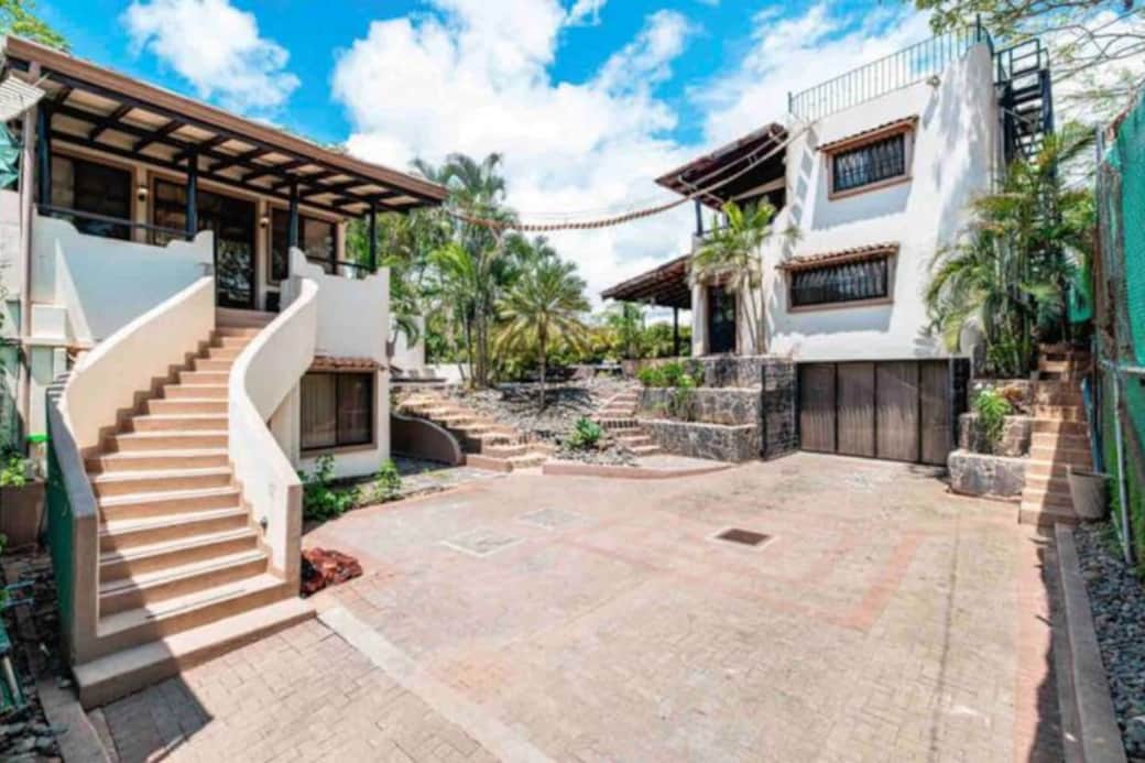 Front view of the property with parking spaces. The Casitas are on the left and the Main House is on the right.