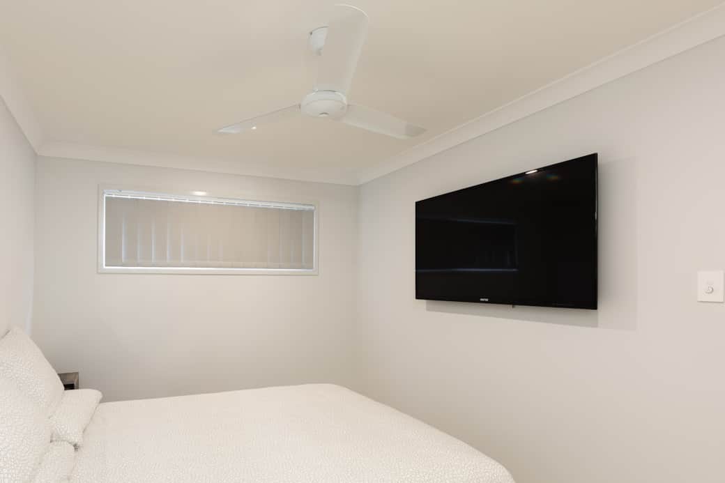 Bedroom: Comfortable room featuring wall-mounted TV