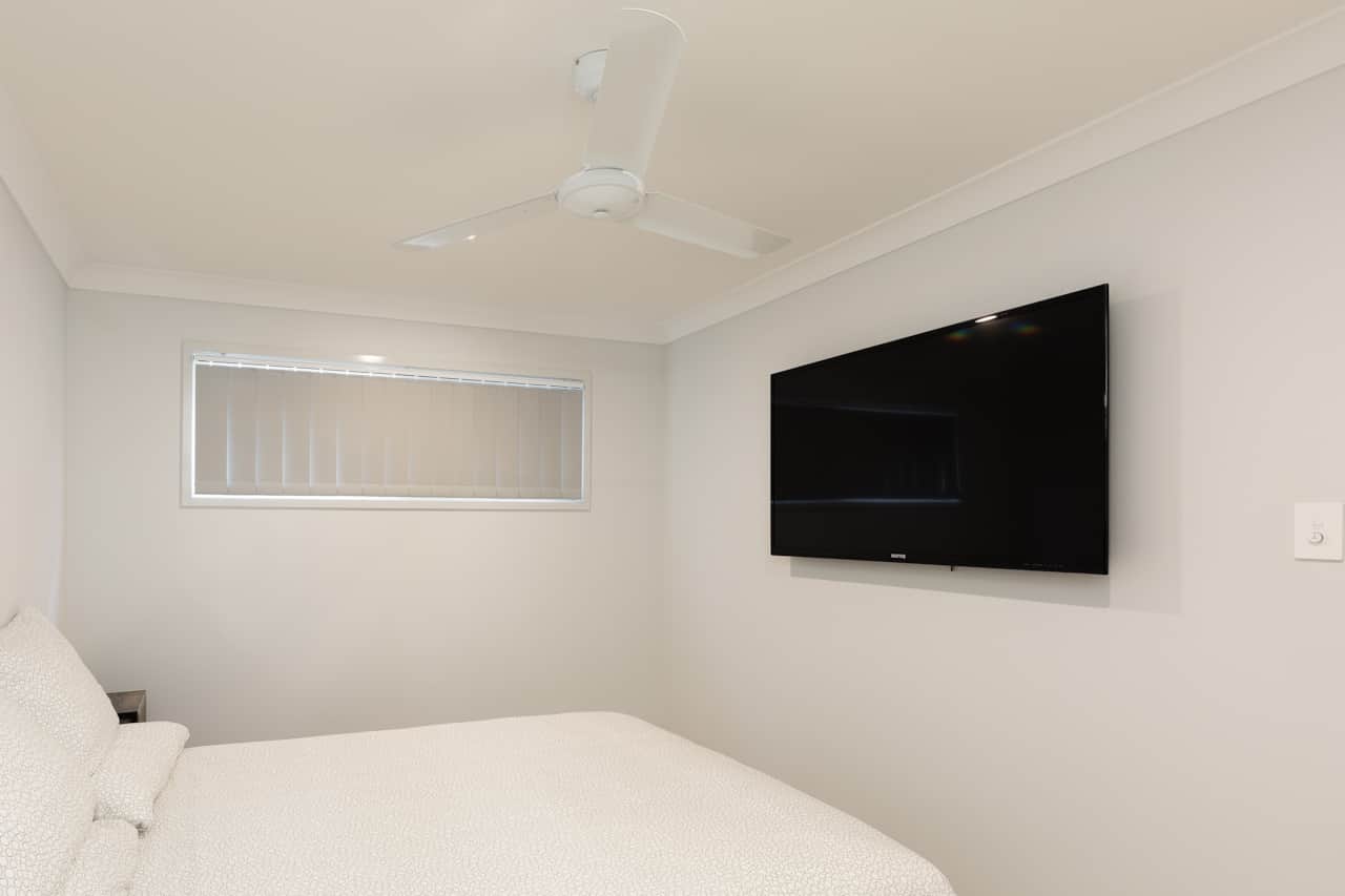 Bedroom: Comfortable room featuring wall-mounted TV
