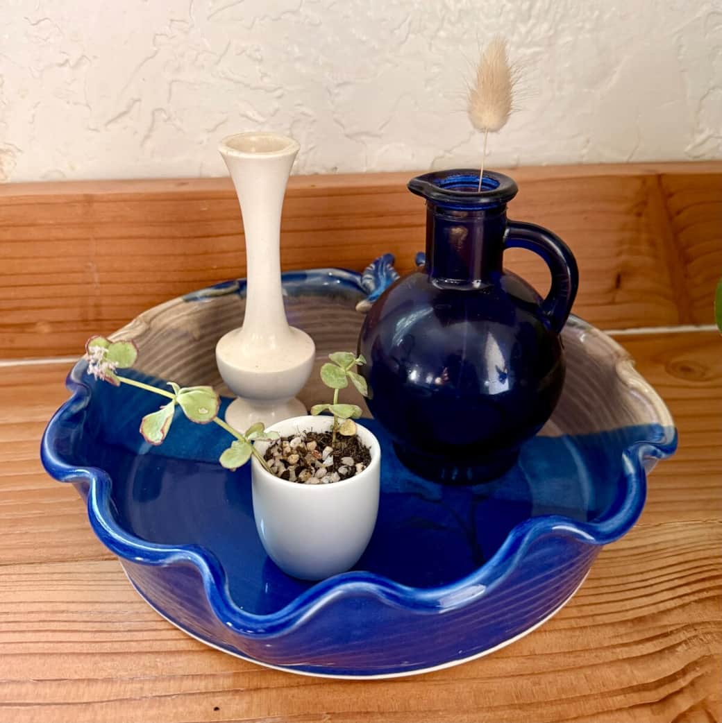 I love hunting for vintage pottery in small antique and thrift shops, and you’ll see some of my favorite finds styled throughout the home. A curated selection is also available for purchase in the Castle Creek gift shop.