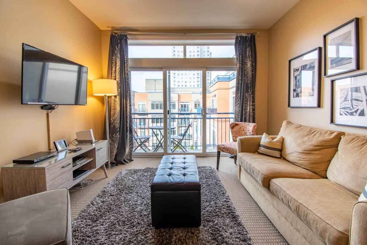 Spacious Living Room with a Private Balcony Overlooking the Serene Courtyard Garden 