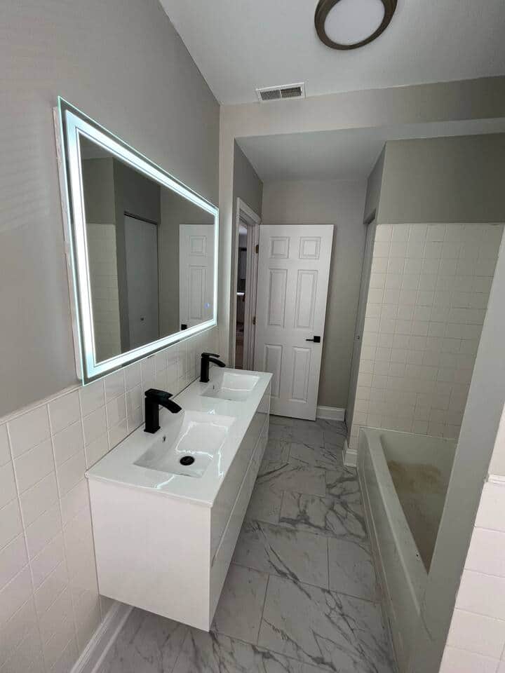 Beautiful big  all new rehabbed bathroom with double sink, lighted mirror, and bathtub.