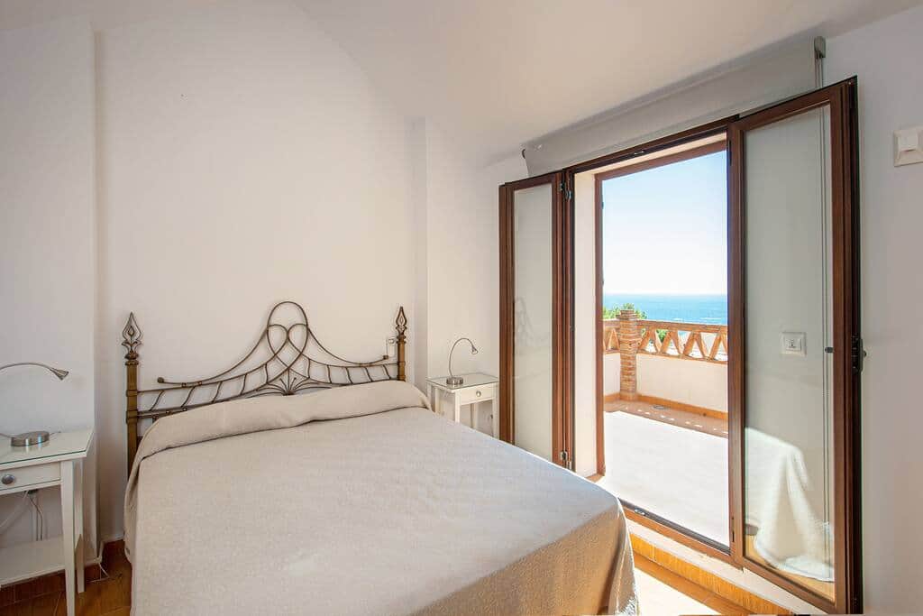 Upper-level bedroom with private terrace and sea view