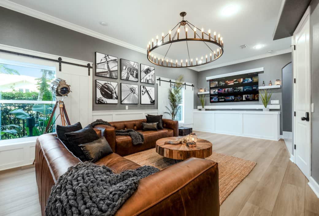 Media lounge with leather seating, nautical art, and a sleek entertainment wall for movie nights. Media lounge with leather seating, nautical art, and a sleek entertainment wall for movie nights.