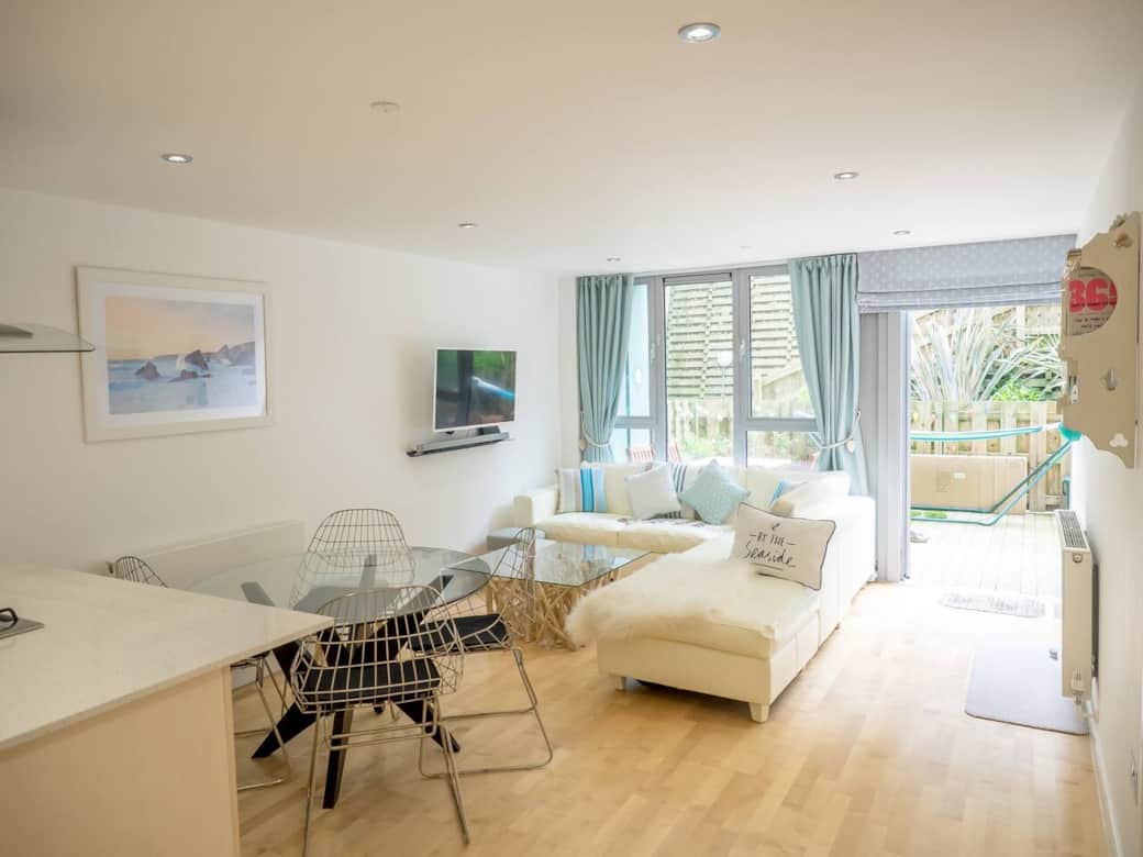 Open plan living area, with door open to private patio