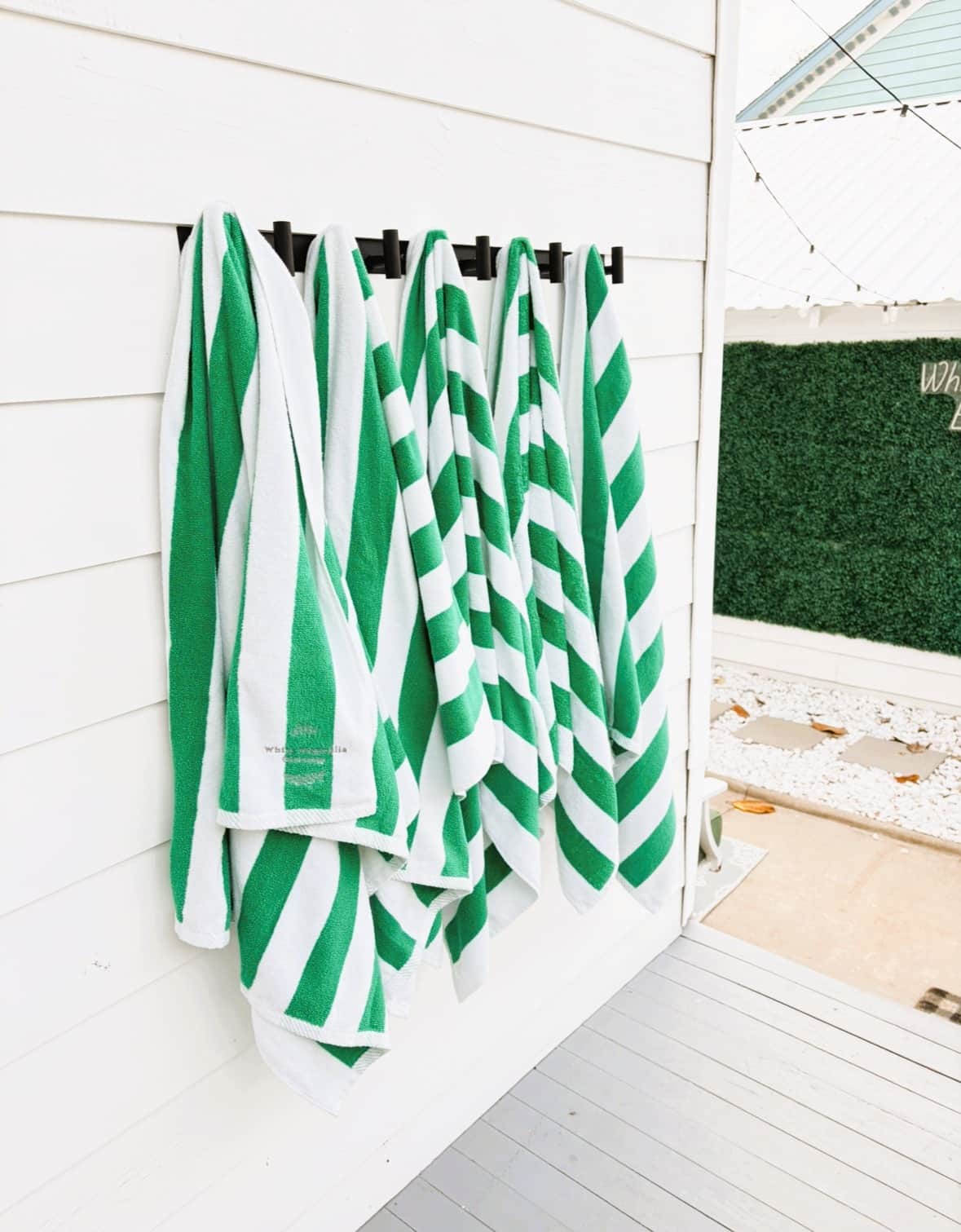 Beach towels with White Magnolia Galveston logo for guest use.