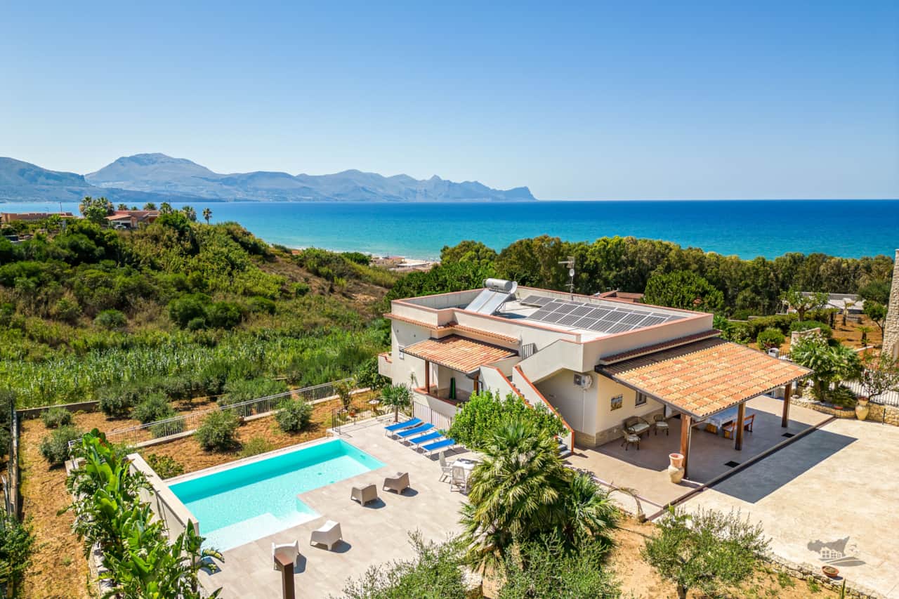 Stunning view of the property showcasing the infinity pool, outdoor area and distance from the sea.