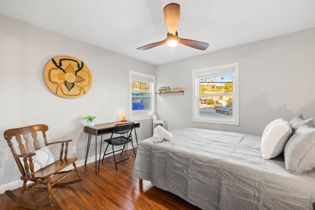 Primary Suite: Queen bed, plush mattress, plenty of natural light, and a cozy chair for relaxing.