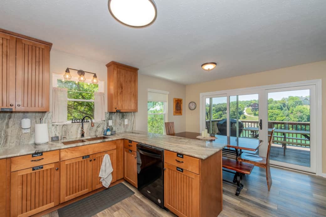 Open kitchen and dining area allow for easy flow. Along with a new gas grill and an outdoor picnic style table for even more dining area.