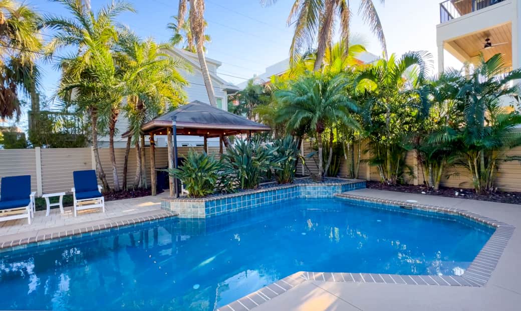 Private, fenced yard and tropical pool with covered tiki bar (dog-friendly)