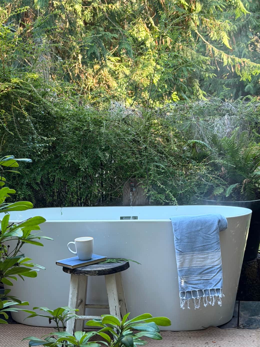 an outdoor bath, tucked beneath the trees. an outdoor bath, tucked beneath the trees.