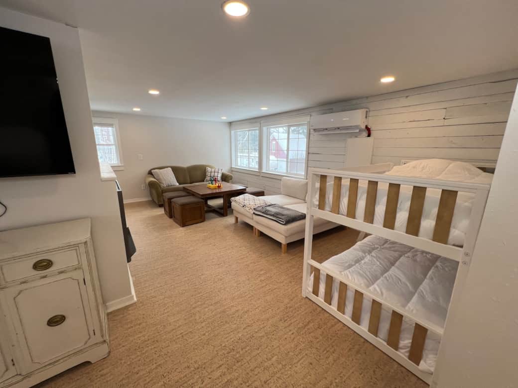 Game room in loft has plenty of seating, blankets to snuggle up with and a low-profile bunk bed (twin over twin)